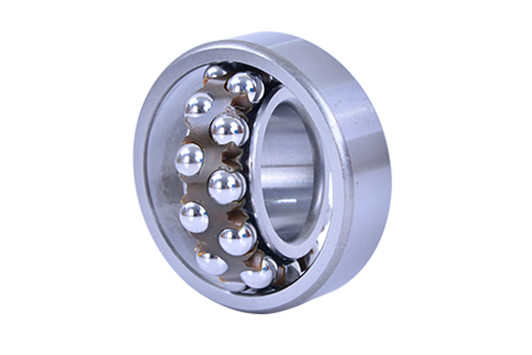 Engineer inspecting deep groove ball bearings on a conveyor system