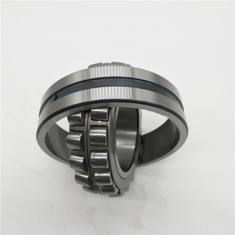 Engineer calculating relubrication interval on a tablet next to machinery