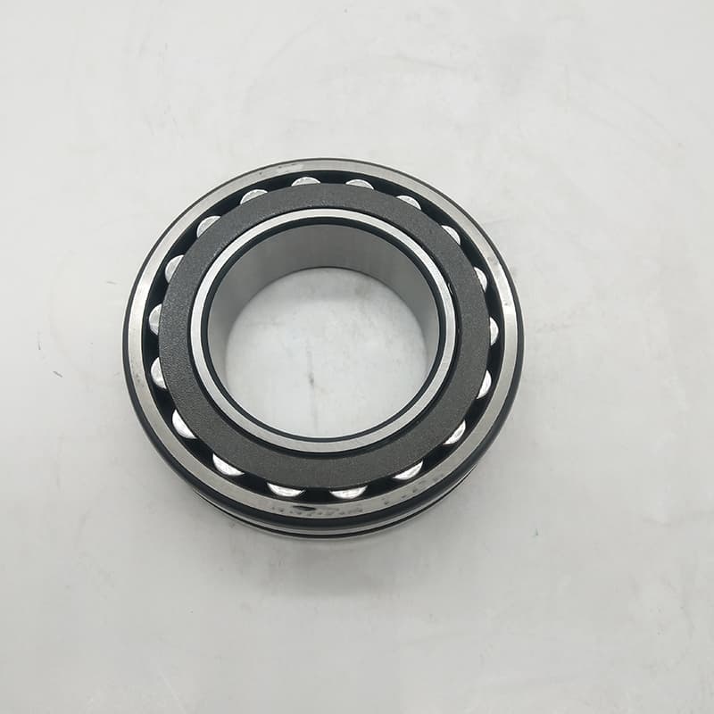 Close-up photo of a bearing showing part number, suffix, and precision class marking