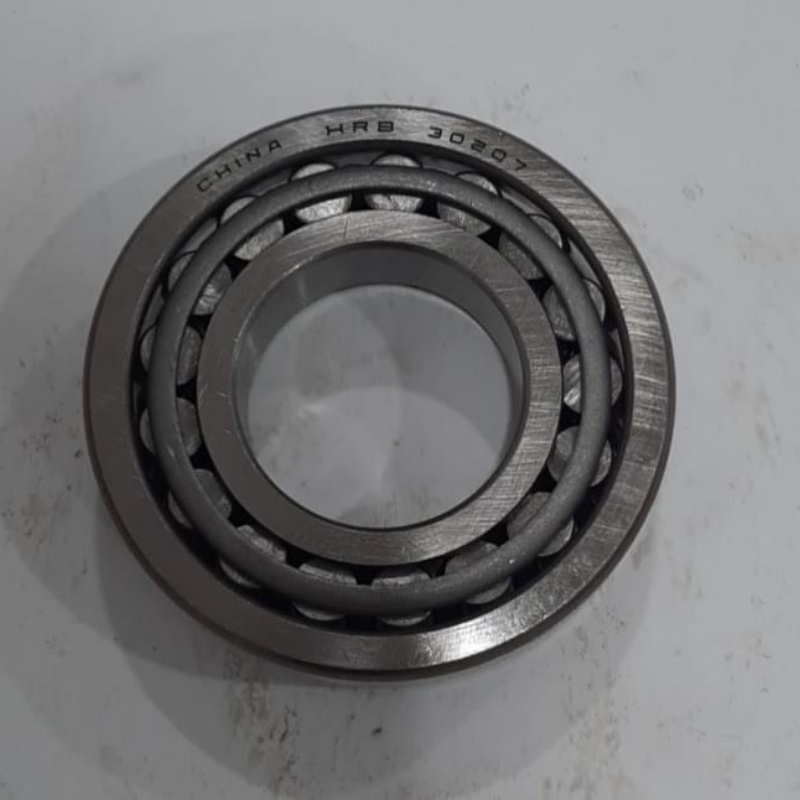 Mechanic disassembling a tapered roller bearing for service